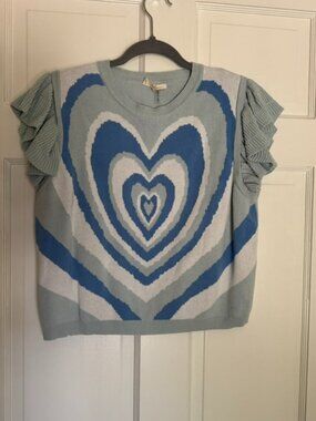 Sleeveless blue knit top with layered heart graphic